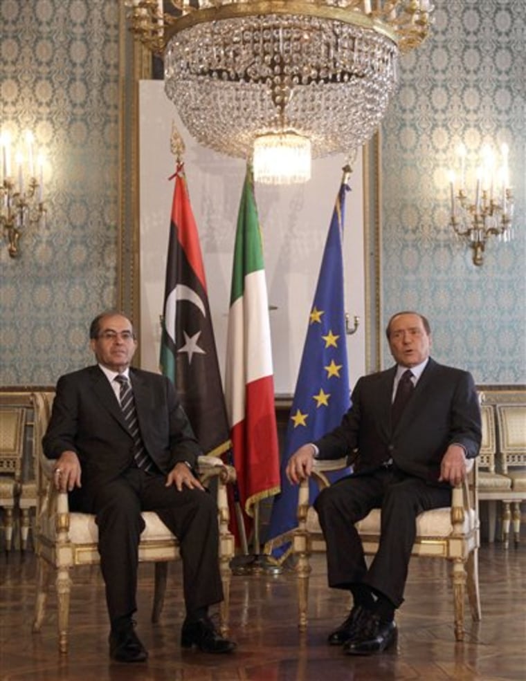 Italian premier Silvio Berlusconi, right, and Mahmoud Jibril, deputy chairman of the Libyan National Transitional Council, meet at the prefecture building in Milan, Italy, Thursday, Aug. 25.